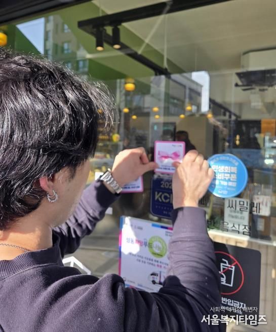 성동형 지속 기부자인 사업체에서 ‘SD리본 스티커’를 부착하고 있는 모습